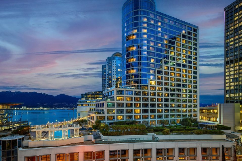 Fairmont Waterfront at dusk beside Canada Place and the harbour